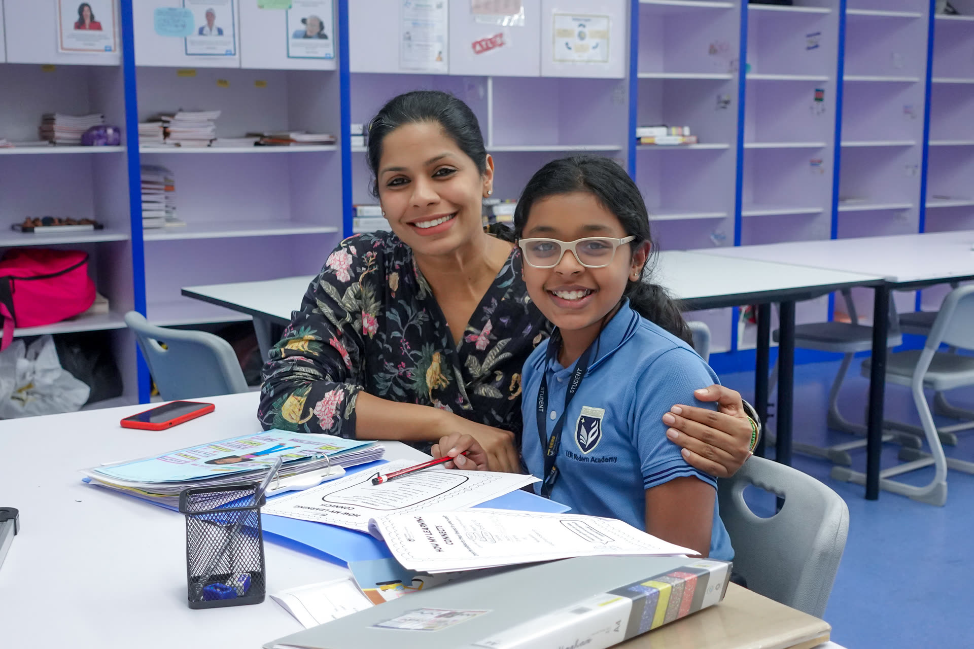 A GEMS teacher supporting a learner in the classroom